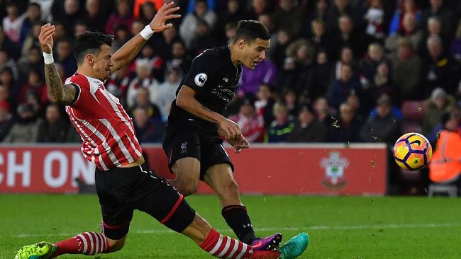 Jose Fonte (L) slides to tackle Liverpool's Brazilian midfielder Philippe Coutinho.