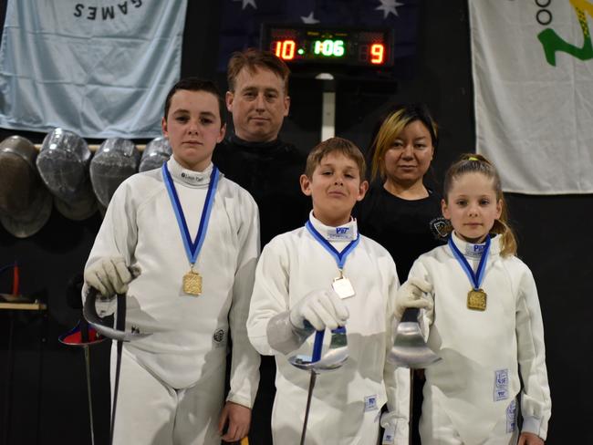 From left to right front row - Jackson Roberts, Alex Lette and Zara Djamirze.From left to right back row - Coach - Michael Howard and club owner - Ange Chheng.