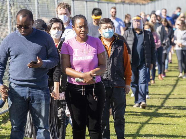 People arrive to get COVID tested at the Parklands Christian College in Park Ridge. Picture: NCA NewsWire / Jono Searle