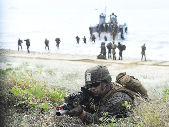 A US Marine is seen as troops disembark from landing craft in the background in Bowen during Exercise Talisman Sabre 2019. Picture: Ian Hitchcock/Getty Images