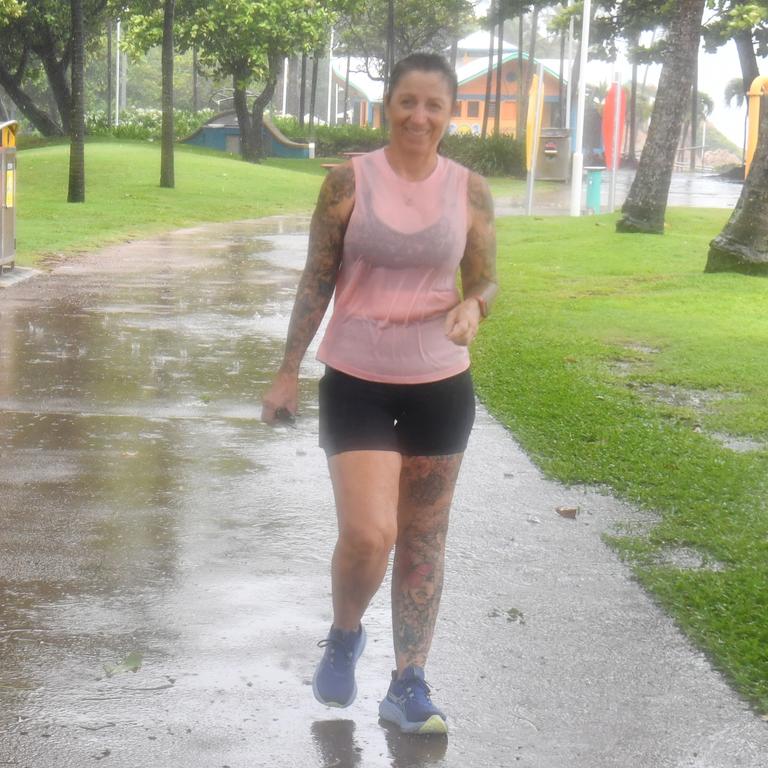 Wet weather in Townsville. Debbie McKay still does her walk along the Strand. Picture: Evan Morgan