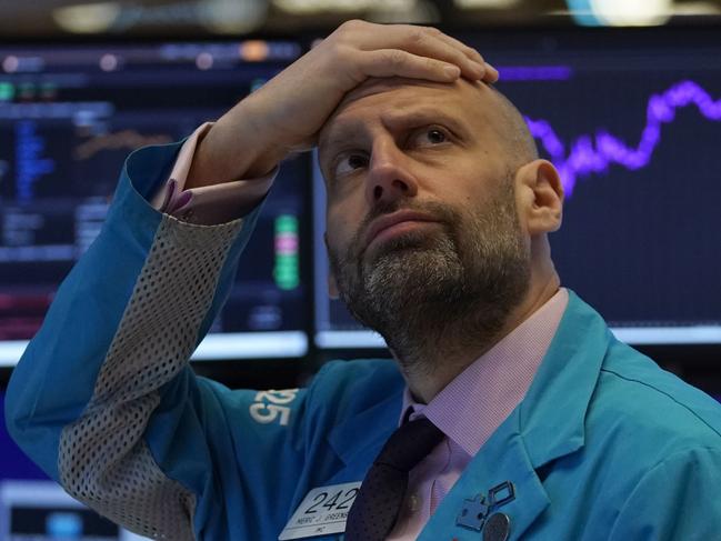 (FILES) In this file photo taken on March 9, 2020 Meric Greenbaum, Designated Market Maker IMC financial looks up at the board before the opening bell right before trading halted on the New York Stock Exchange on in New York. - Wall Street stocks finished another rocky session much lower on March 23, 2020 amid partisan squabbling over a giant stimulus package as the Federal Reserve announced new emergency measures. (Photo by TIMOTHY A. CLARY / AFP)