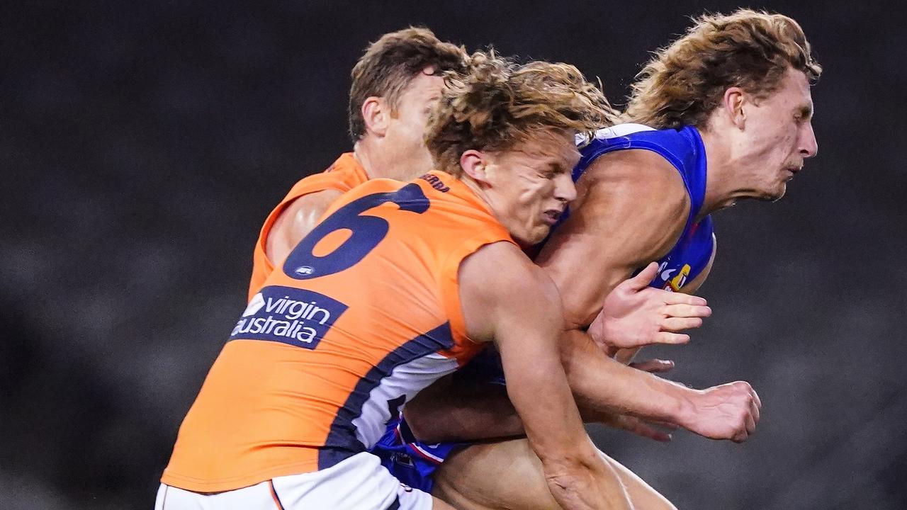 Aaron Naughton bumps Lachie Whitfield, leaving him concussed. (AAP Image/Scott Barbour)