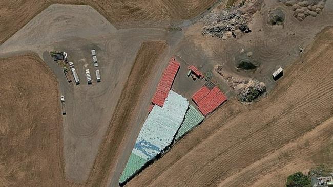 Google Maps satellite photos show green bins sitting in the Willawong council depot.
