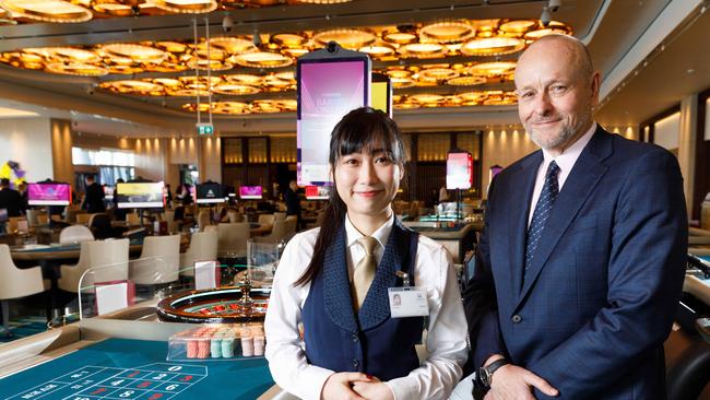 Crown Sydney CEO Mark McWhinnie and roulette dealer Iris. Picture by Max Mason-Hubers