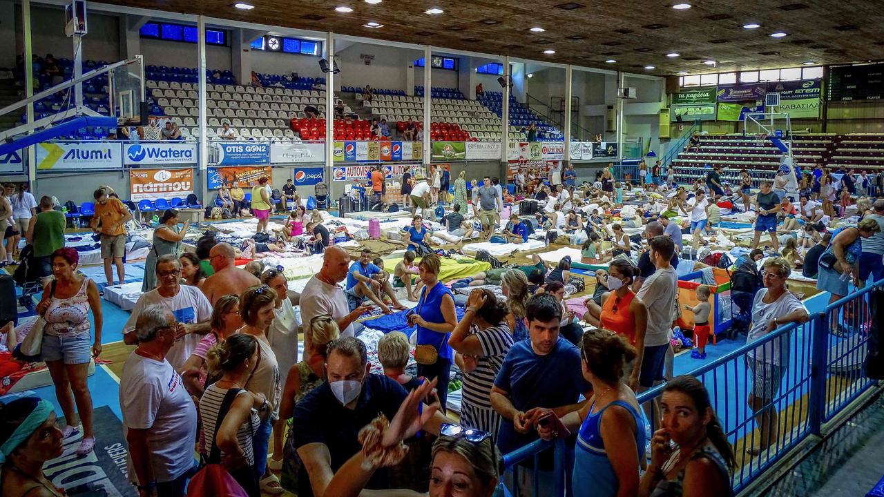 Tourists stayed overnight in a basketball hall after fleeing from their hotels. Picture: Stringer / Eurokinissi / AFP