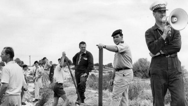 Police cadets and members of the police emergency operations group searched sandhills at North Glenelg and West Beach for the fourth time days after the disappearance of the Beaumont children. Senior Constable B. Higgs directing the search at West Beach.