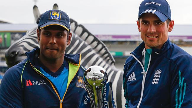 England cricket captain Alastair Cook and Sri Lanka's captain Angelo Mathews (L) pose for a photograph with the trophy at Headingley.