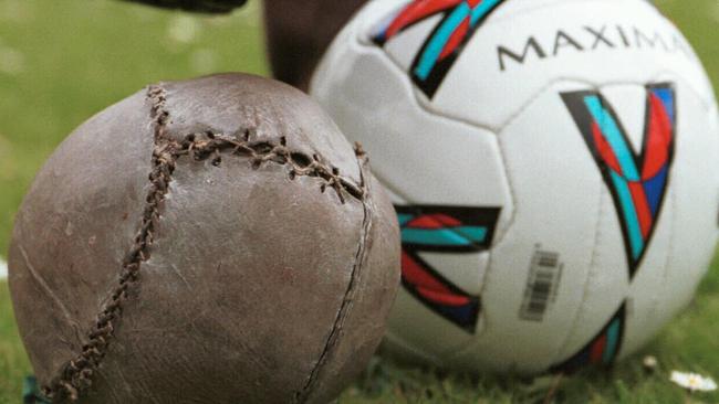 The world's oldest surviving soccer ball, possibily played with by Mary Queen of Scots, is displayed at the Smith Art Gallery, Stirling, Scotland, next to its modern equivalent.