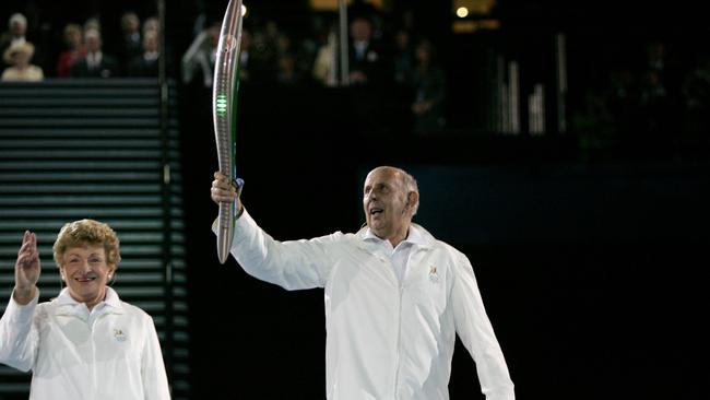 Governor of Victoria John Landy carries the Queen's Baton during the Opening Ceremony for the Melbourne 2006 Commonwealth Games. Photo by Ryan Pierse/Getty Images