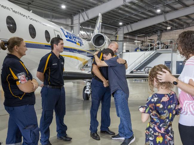 Chris Garner gives CareFlight pilot Nick Palad an emotional hug reuniting after his lung collapsed and he nearly lost his life, eight months ago. Picture: Floss Adams.