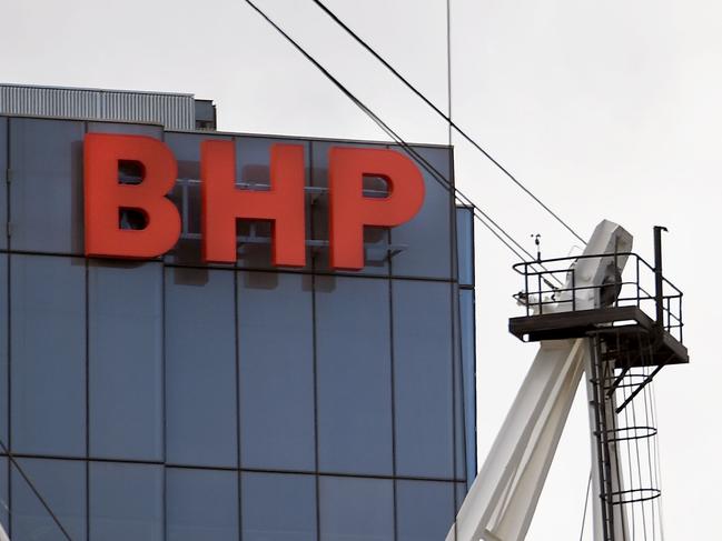 A BHP sign adorns the side of their headquarters in Melbourne on February 19, 2019. - Anglo-Australian mining giant BHP posted an underlying profit of 3.73 billion US dollars on February 19, in a lower-than-expected first-half result after a series of operational problems at its mines. (Photo by William WEST / AFP)