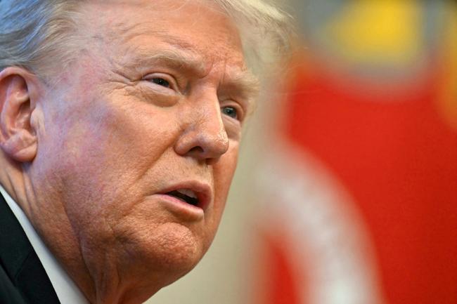 US President Donald Trump speaks to the press after signing an Executive Order at the Oval Office of the White House in Washington