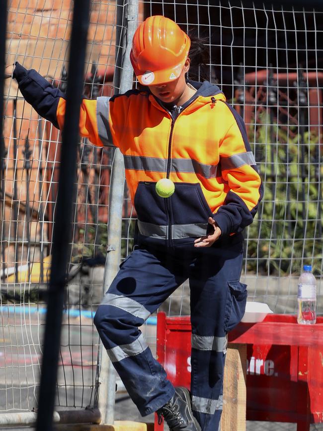 Holt and Devonshire streets, Surry Hills: 1pm. A road worker keeps busy with a tennis ball.