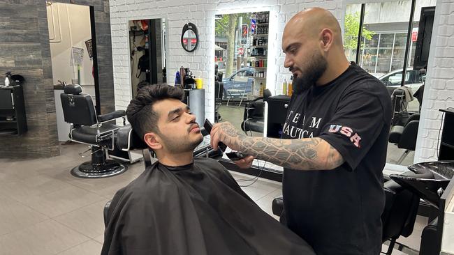 Barber and manager of North Sydney Barbers Jake Azar had to close his business early on Wednesday due to the catastrophic Optus service outage. Picture: Georgina Noack