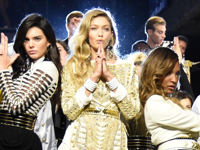 NEW YORK, NY - OCTOBER 20: Models Kendall Jenner, Gigi Hadid, and Jourdan Dunn pose on the runway with other models at the BALMAIN X H&M Collection Launch at 23 Wall Street on October 20, 2015 in New York City. (Photo by Nicholas Hunt/Getty Images for H&M)