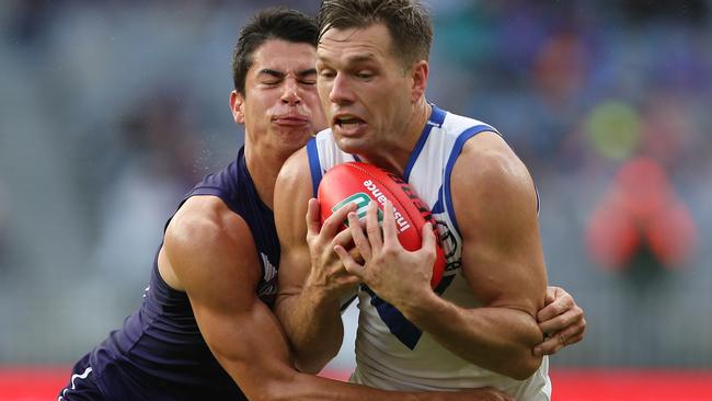 Shaun Higgins is tackled by Bailey Banfield.