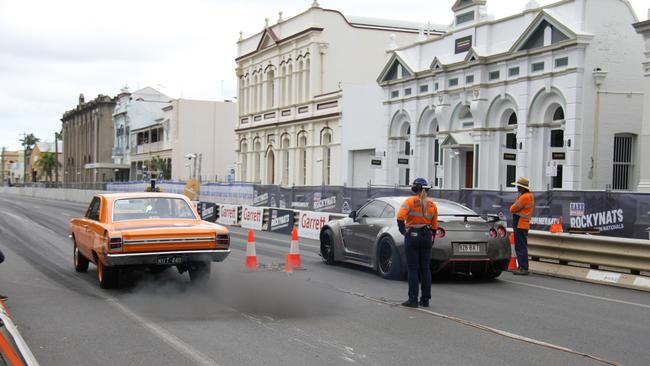 Shane Cattle launches off the line in his 440 big block Dodge hard top against a R35 Skyline GTR in the Rockynats street drags. Picture: Rodney Stevens