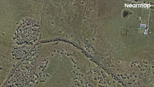 The estimated economic loss reached $2.2 billion, prompting the Australian government to pledge $200 million toward strengthening community resilience. Oxley Island before. Picture: Nearmap