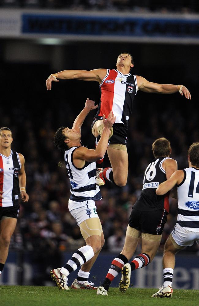 Michael Gardiner flies over Shane Mumford at then-Tesltra Dome in 2009.