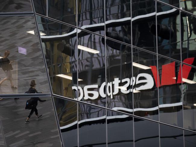 Commuters, reflected on a building walk near Westpac Banking Corp. signage in Sydney, Australia, on Monday Nov. 11, 2019. Photographer: Brent Lewin/Bloomberg