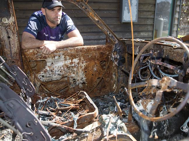 Melbourne Storm players helping out in fire affected town of Sarsfield near Bairnsdale.  22/02/2020.  Skipper Cameron Smith checks out a burnt out car that was only a metres from the Bob and Virginia King's house that wasn't touched   . Pic: Michael Klein