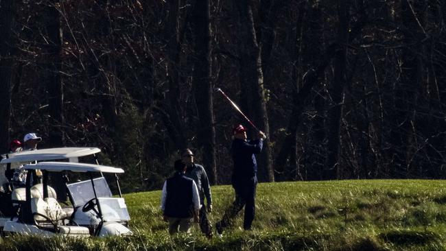 Donald Trump plays out of the rough at his golf club in Sterling, Virginia, on Sunday. Picture: AFP