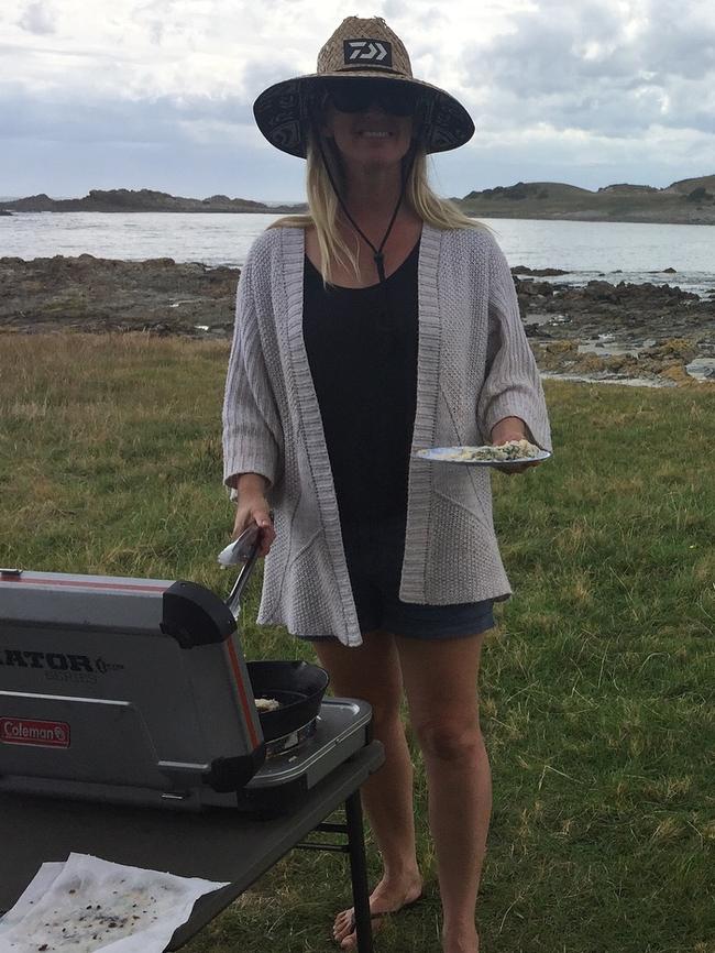 Mia cooking freshly-caught fish off Tasmania’s west coast.