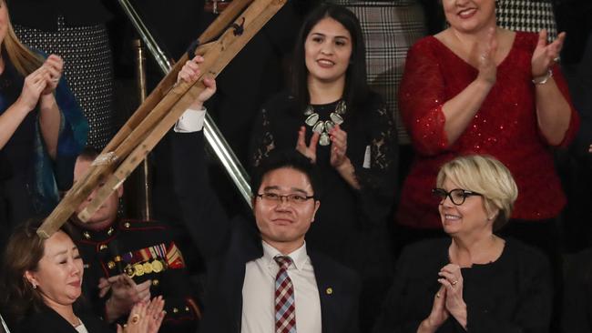 Ji Seong-ho, a North Korean defector, holds up his crutches after his introduction by President Trump during the State of the Union address to a joint session of Congress on Capitol Hill in Washington, Tuesday, Jan. 30, 2018. (AP Photo/J. Scott Applewhite)