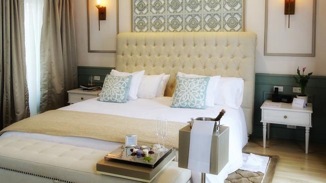 A suite’s king bed, with hand-embroidered linen.