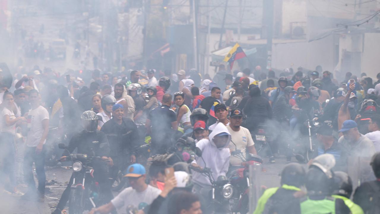 Riot police use tear gas against demonstrators during a protest. Picture: Yuri CORTEZ / AFP