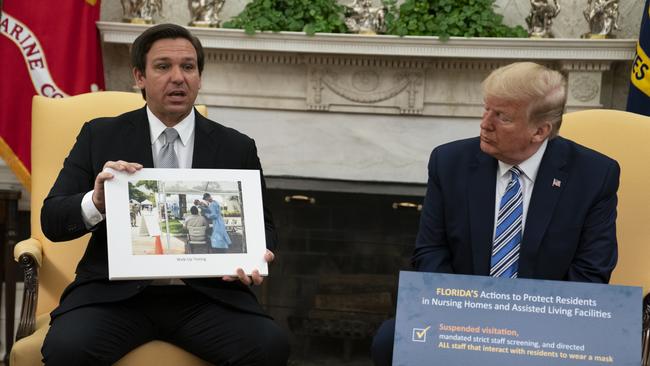 President Donald Trump listens as Florida Governor Ron DeSantis talks about the coronavirus response last week. Picture: AP