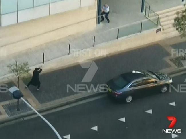 Channel 7 video frame grabs of the moment Jabar started firing a gun in front of Parramatta police station.