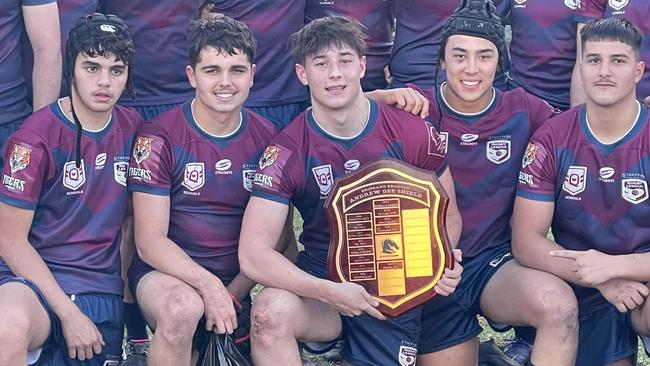 Stretton State College won the Gee Shield. Jack McCosker, captain, with the shield.