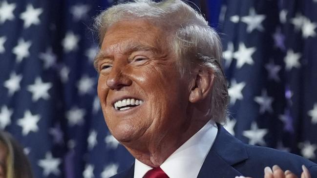 Republican presidential nominee former President Donald Trump stands on stage with former first lady Melania Trump, as Lara Trump watches, at an election night watch party at the Palm Beach Convention Center, Wednesday, Nov. 6, 2024, in West Palm Beach, Fla. (AP Photo/Evan Vucci)