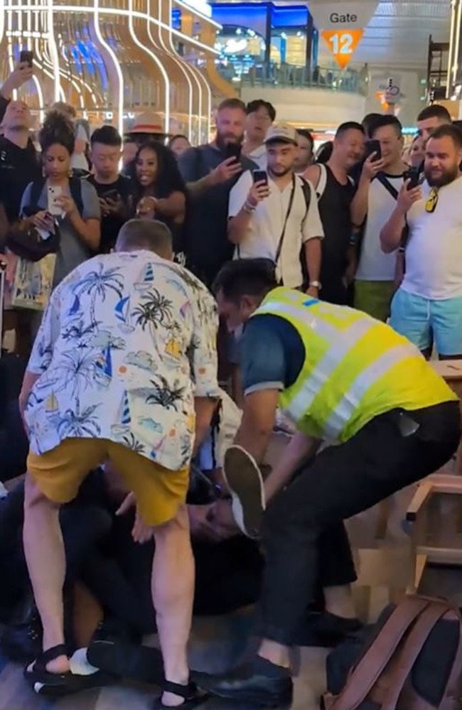 Drunk Aussie wrestled to the ground by armed airport police after being told 'no more’ alcohol. Picture: Viral Press