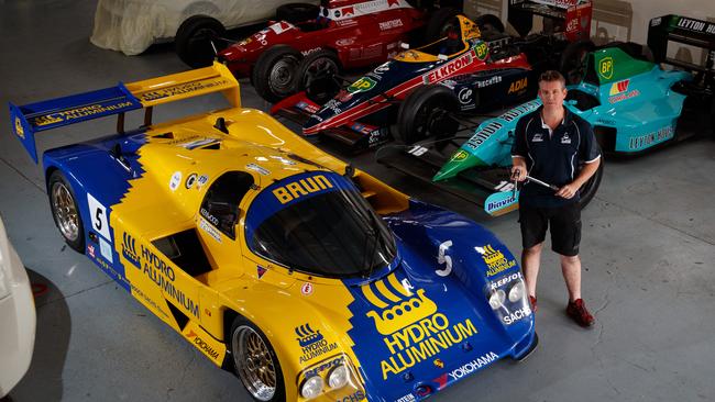 Mark Rundle BRM owner with a LeMans Porsche and F1 cars in his workshop ahead of the Motorsport Festival. Picture: Matt Turner