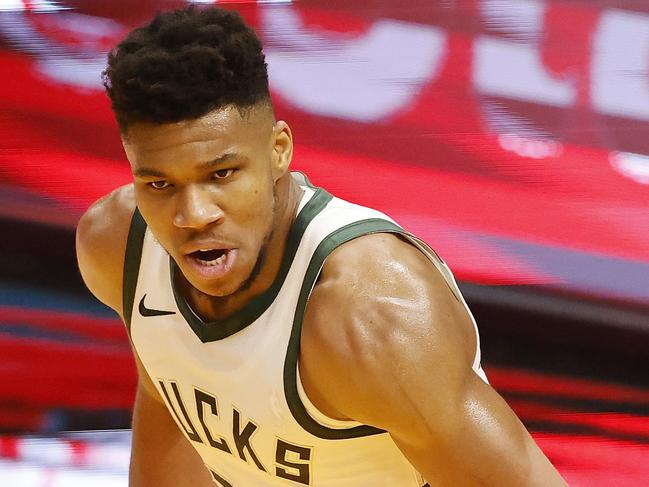 MIAMI, FLORIDA - DECEMBER 29: Giannis Antetokounmpo #34 of the Milwaukee Bucks reacts after a dunk against the Miami Heat during the first quarter at American Airlines Arena on December 29, 2020 in Miami, Florida. NOTE TO USER: User expressly acknowledges and agrees that, by downloading and or using this photograph, User is consenting to the terms and conditions of the Getty Images License Agreement.   Michael Reaves/Getty Images/AFP == FOR NEWSPAPERS, INTERNET, TELCOS & TELEVISION USE ONLY ==