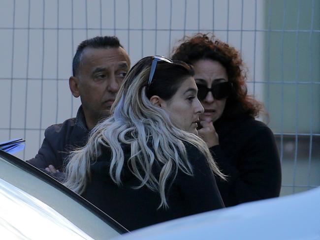 Relatives of the dead man arrive at the apartment complex today. Picture: John Grainger