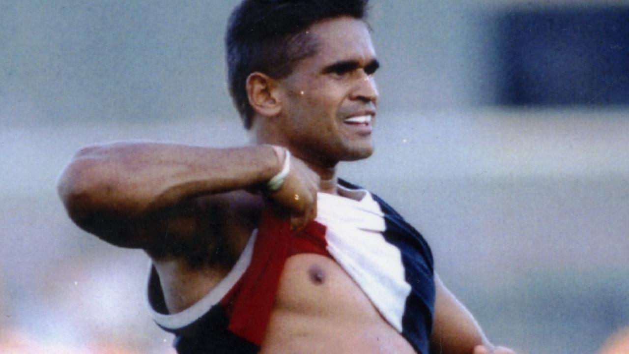 Footballer Nicky Winmar lifts his guernsey and pointing to his skin says "I'm black and I'm proud" to jeering Collingwood fans.