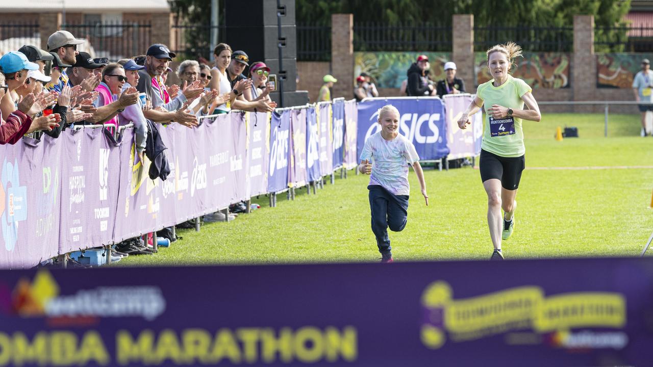 Kathryn Parkinson, running with her daughter Madison Jones, is the first female to finish the Toowoomba Marathon, Sunday, May 5, 2024. Picture: Kevin Farmer