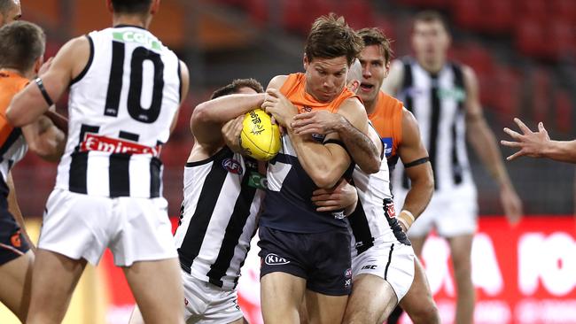 Toby Greene is tackled by two Collingwood players. Picture: Getty Images