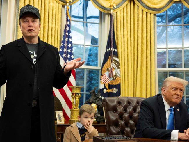 TOPSHOT - Elon Musk speaks as his son X Ã A-Xii and US President Donald Trump look on in the Oval Office of the White House in Washington, DC, on February 11, 2025. Tech billionaire Elon Musk, who has been tapped by President Donald Trump to lead federal cost-cutting efforts, said the United States would go "bankrupt" without budget cuts. Musk leads the efforts under the newly created Department of Government Efficiency (DOGE), and was speaking at the White House with Trump, who has in recent weeks unleashed a flurry of orders aimed at slashing federal spending. (Photo by Jim WATSON / AFP)