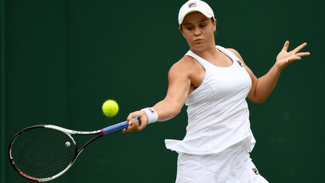 Ashleigh Barty returns serve.