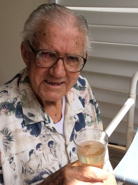 Jack Concannon enjoys a glass of champagne after being serenaded by neighbours.