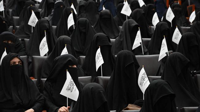 Veiled students hold Taliban flags as they listen women speakers before a pro-Taliban rally at the Shaheed Rabbani Education University in Kabul on September 11, 2021. Picture: Aamir Qureshi/AFP