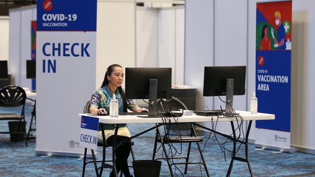 Administration staff member Jacky Ramsay at the check-in counter of the mass vaccination hub at the Cairns Convention Centre. Picture: Brendan Radke