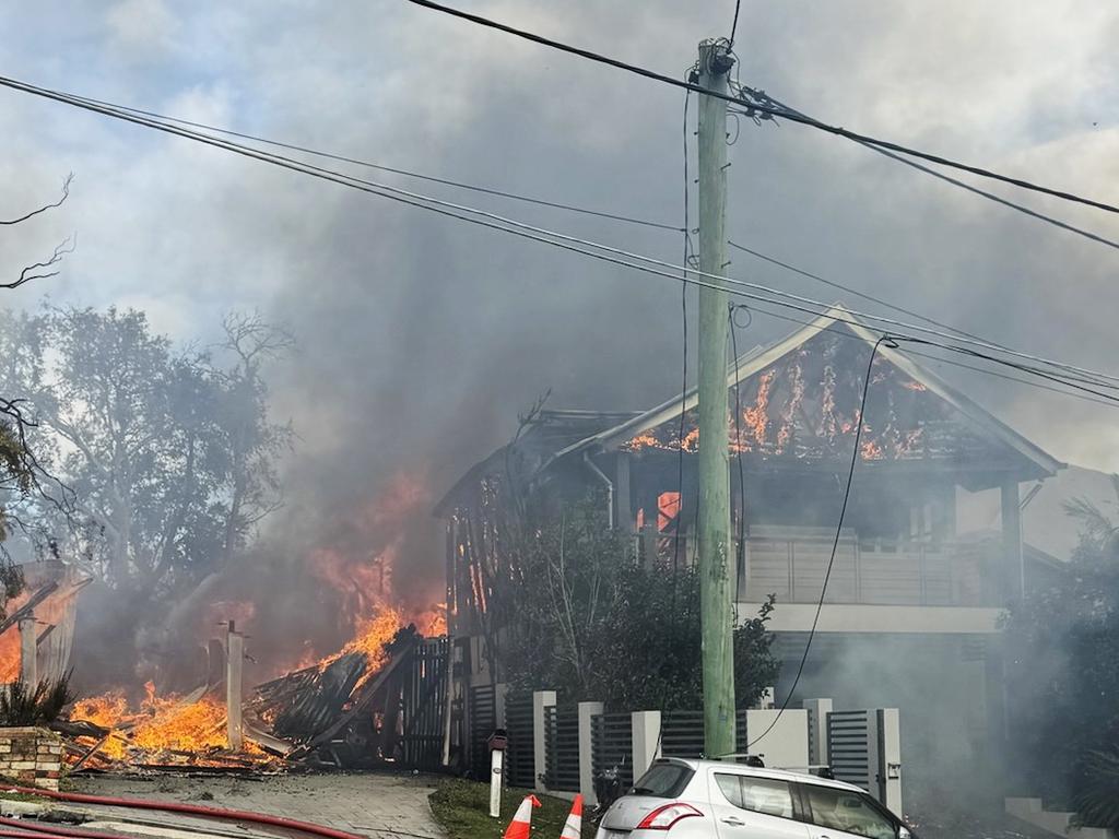 Fire crews are battling multiple house fires in Evelyn Street in Grange. Photo: QFES.