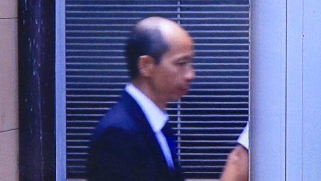 Guilty: Robert Xie is taken from the Supreme Court to a waiting prison van after being found guilty. Picture: AAP