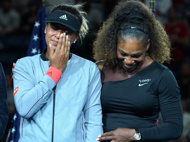 TOPSHOT - US Open Womens Single champion Naomi Osaka of Japan (L) with Serena Williams of the US during their Women's Singles Finals match at the 2018 US Open at the USTA Billie Jean King National Tennis Center in New York on September 8, 2018. (Photo by TIMOTHY A. CLARY / AFP)